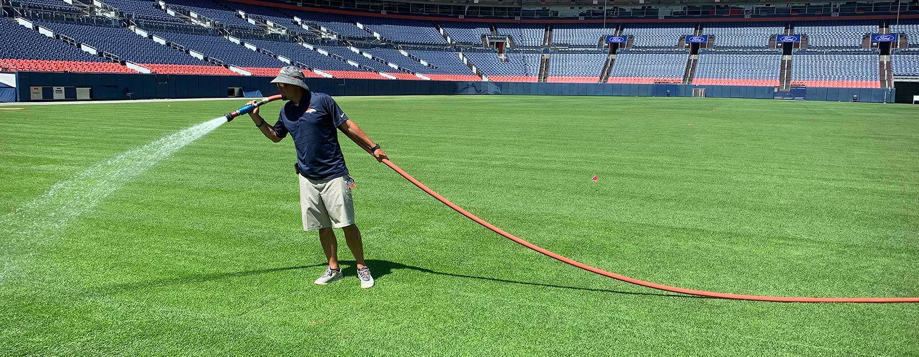 New sod get watered after being installed in a stadium in Denver, Colorado by Chris.