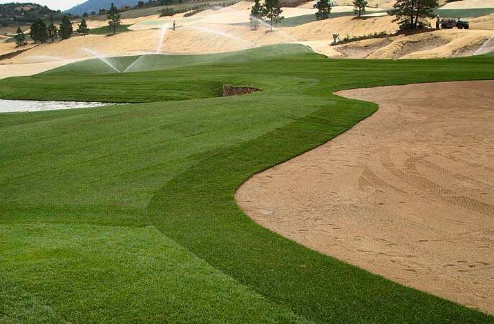 A freshly sodded greens complex gets watered after big rolls have been installed in Littleton, Colorado at The Club at Ravenna