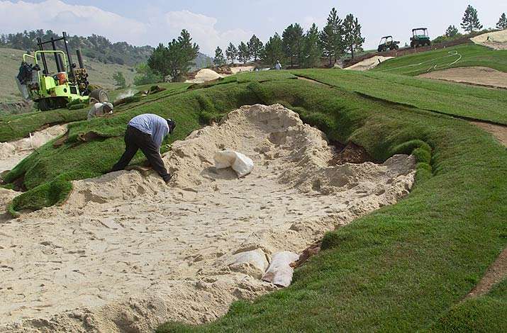 Big roll sod is installed on a bunker at The Club at Ravenna in Littleton, CO.
