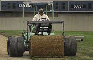 A sand based big roll of sports sod in installed at Falcon Stadium in Colorado Springs, CO at the Air Force Academy.