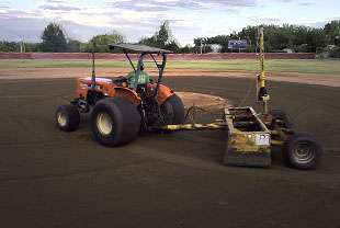A baseball field infield is graded prior to sodding with big roll sod at Heritage HS in Littleton, CO.
