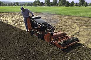 A Toro Dingo reverse till soil cultivator is used to prepare the soil before sodding.