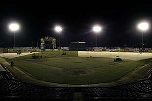Overhead view of Sky Sox baseball field big roll sod installation at night.